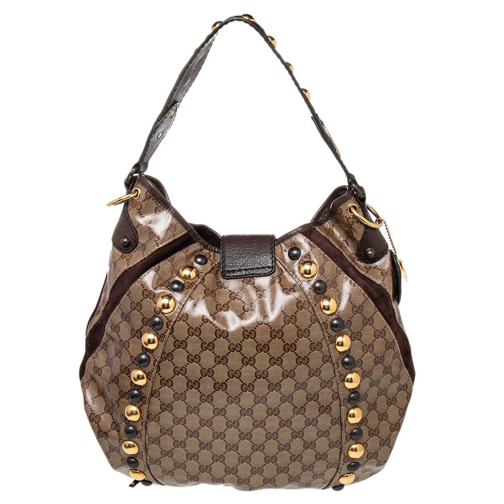 Let your stylish self come alive with this stunning Gucci Babouska hobo bag. Crafted in GG crystal canvas and leather, it features tassels with studs, handle with metal detailing. Its spacious interior is lined with canvas that features a zipped