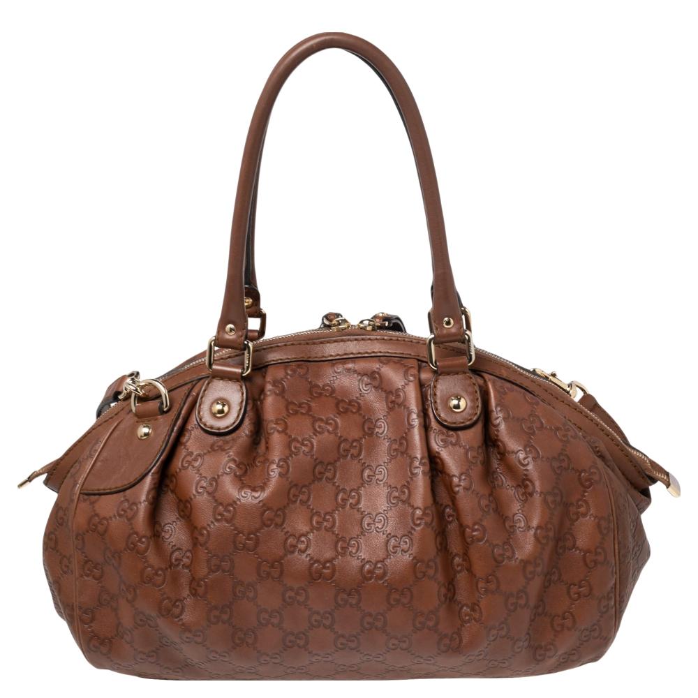 The Sukey is one of the best-selling designs from Gucci and we believe you deserve to have one too. Crafted from GG leather and equipped with a spacious interior, this bag is ideal for work and after. It is complete with two handles, a strap, and a