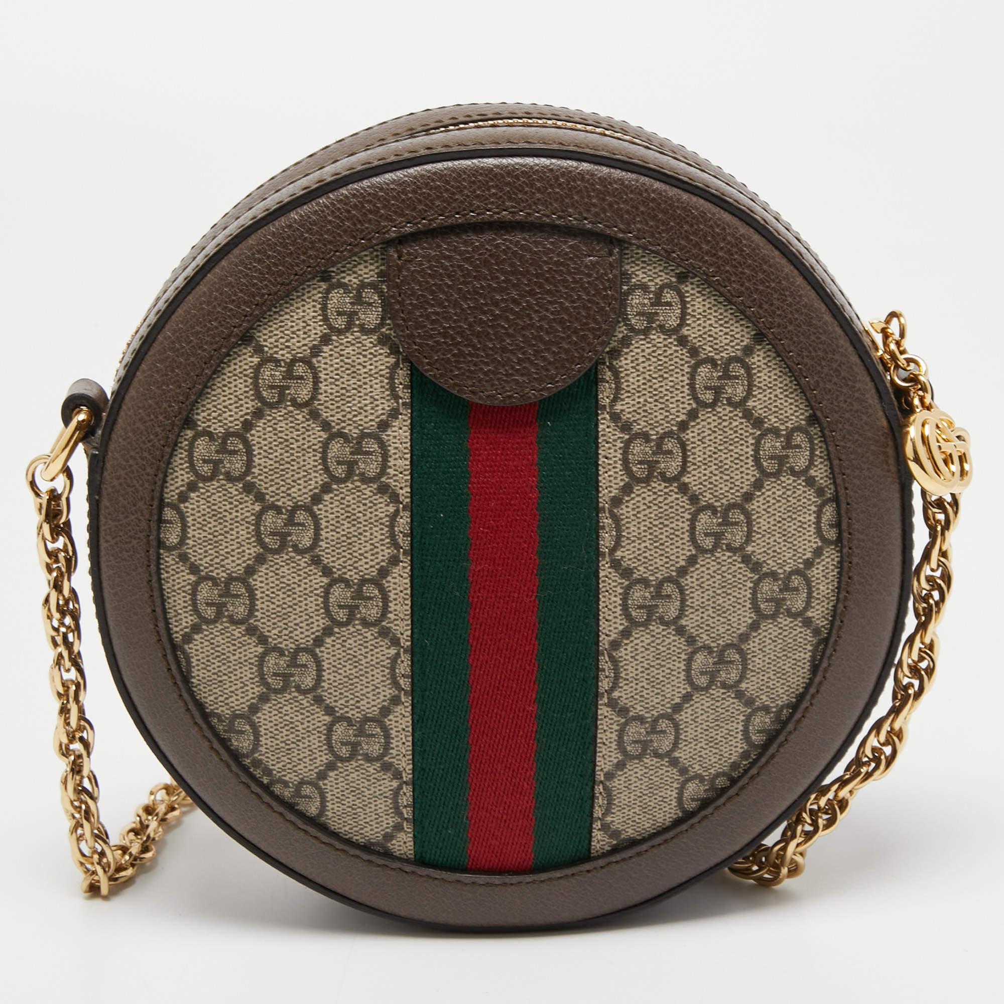 Gucci's iconic collections exhibit the label's varied aesthetics and skill. This mini Ophidia bag is overlaid with signature elements, thus giving it an exceptional look. It is created using brown coated canvas and leather with the Web trim adorning
