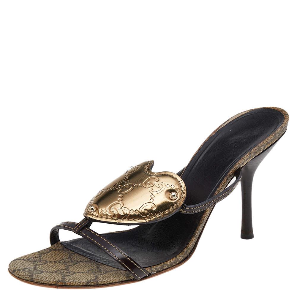 Sweetly complementing your short dresses for casual outings, these sandals from Gucci are crafted with leather featuring a heart-shaped crest on the frontal straps. Set on 10 cm heels, these are complete with leather soles.