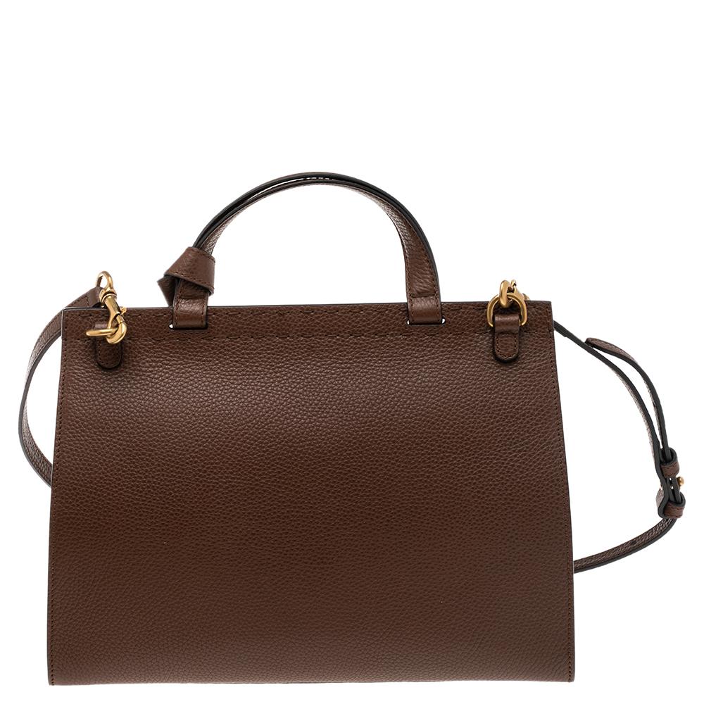 A structured and minimal bag can assist you with many outings and can be styled with most of your attires. Gucci's bag is an example of the label’s penchant for creating staple pieces. It is crafted from grained leather in a brown shade and features