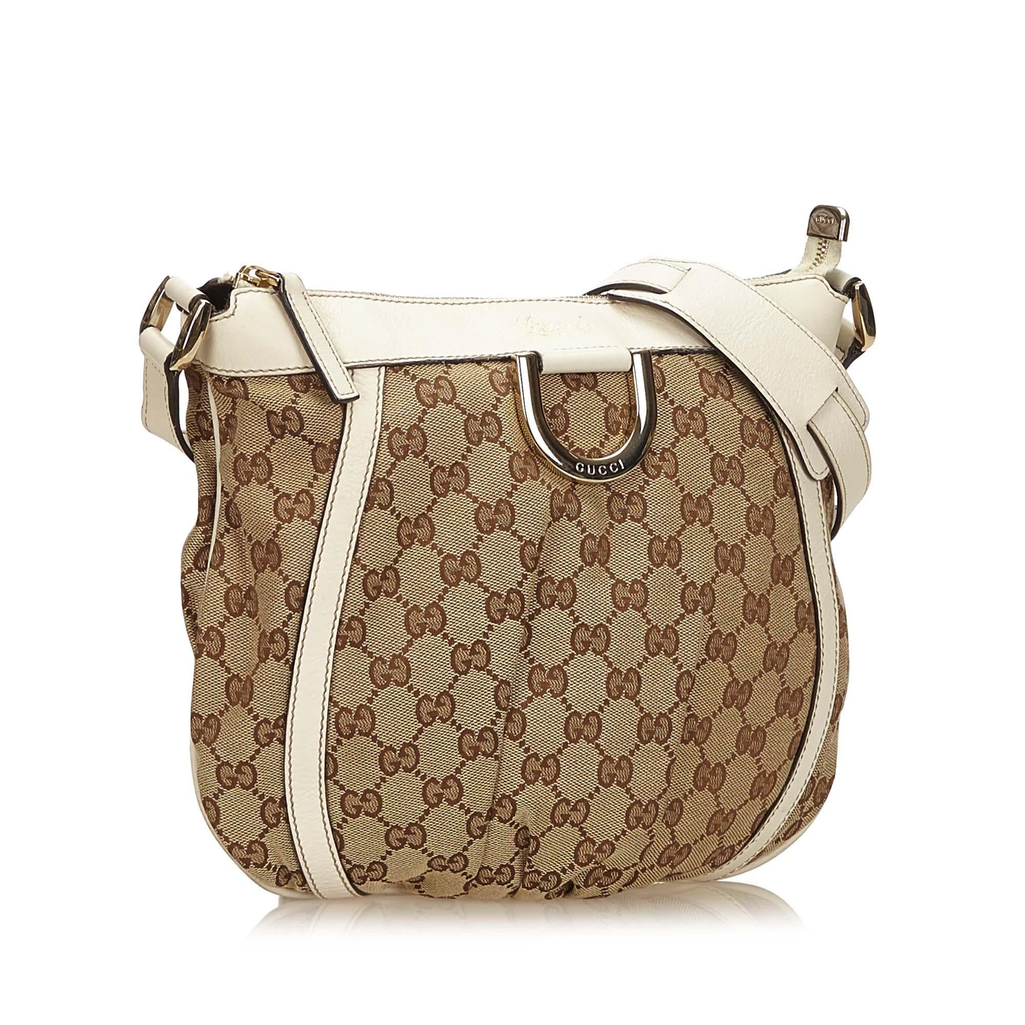 This crossbody bag features a jacquard body with leather trim, flat leather strap, top zip closure, and interior zip pocket. It carries as B+ condition rating.

Inclusions: 
This item does not come with inclusions.

Dimensions:
Length: 26.00