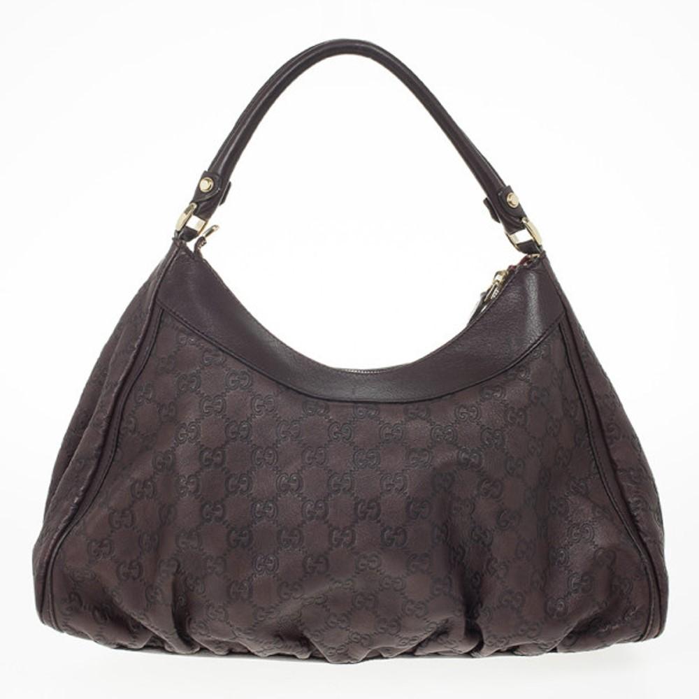 Go for a chic statement with this practical Guccissima D Ring hobo by Gucci. This pleated hobo is crafted from brown monogram GG leather with smooth trim and it also features a large D ring, comfortable double rolled leather handles and gold tone