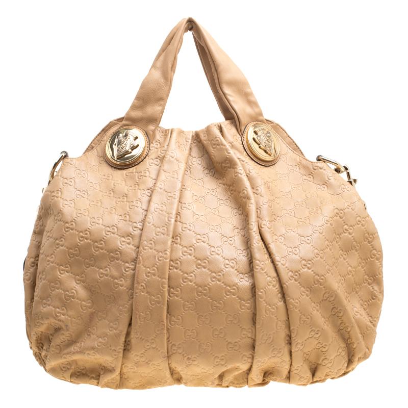 This Gucci hobo is built for everyday use. Crafted from the signature Guccissima leather, it has a brown exterior and two handles for you to easily parade it. The interior is spacious and the hobo is complete with gold-tone hardware.

Includes: