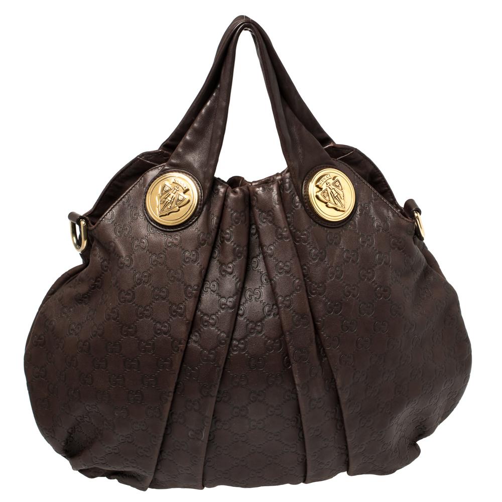 This Gucci hobo is built for everyday use. Crafted from Guccissima leather, it has a brown exterior and two handles and a detachable shoulder strap for you to easily parade it. The fabric insides are sized well and the hobo is complete with the