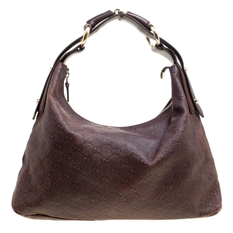 Gucci brings to you this instantly recognisable hobo. Made in Italy, the bag is crafted from Guccissima leather and features a horsebit detail on the handle. The zip closure opens to a fabric lined interior that has enough space to hold all your
