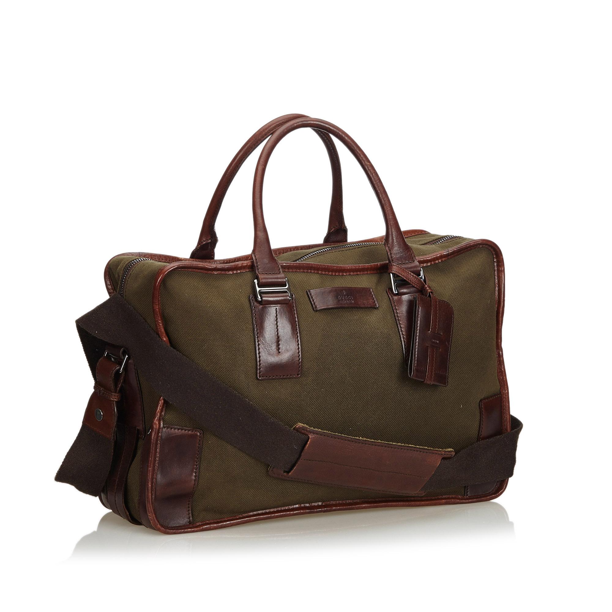 This business bag features a canvas body with leather trim, rolled leather handles, a flat strap, a top zip closure, and an interior zip pocket. It carries as B condition rating.

Inclusions: 
This item does not come with