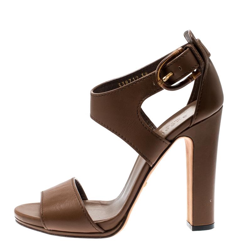 Beauty flows out of these sandals from Gucci! Crafted from brown leather, these sandals have a single front strap across the toes, closed counters with bamboo buckles and 12 cm heels to help you stand tall.

Includes: The Luxury Closet Packaging

