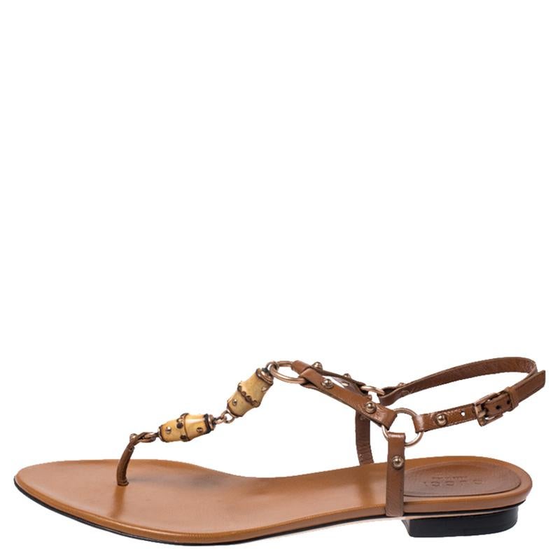 Step out style-ready in this pair of thong sandals from Gucci. They've been crafted from leather and styled with gold-tone hardware and bamboo motifs along the front and buckle fastenings at the ankle. Flaunt them with dresses and shorts.

Includes: