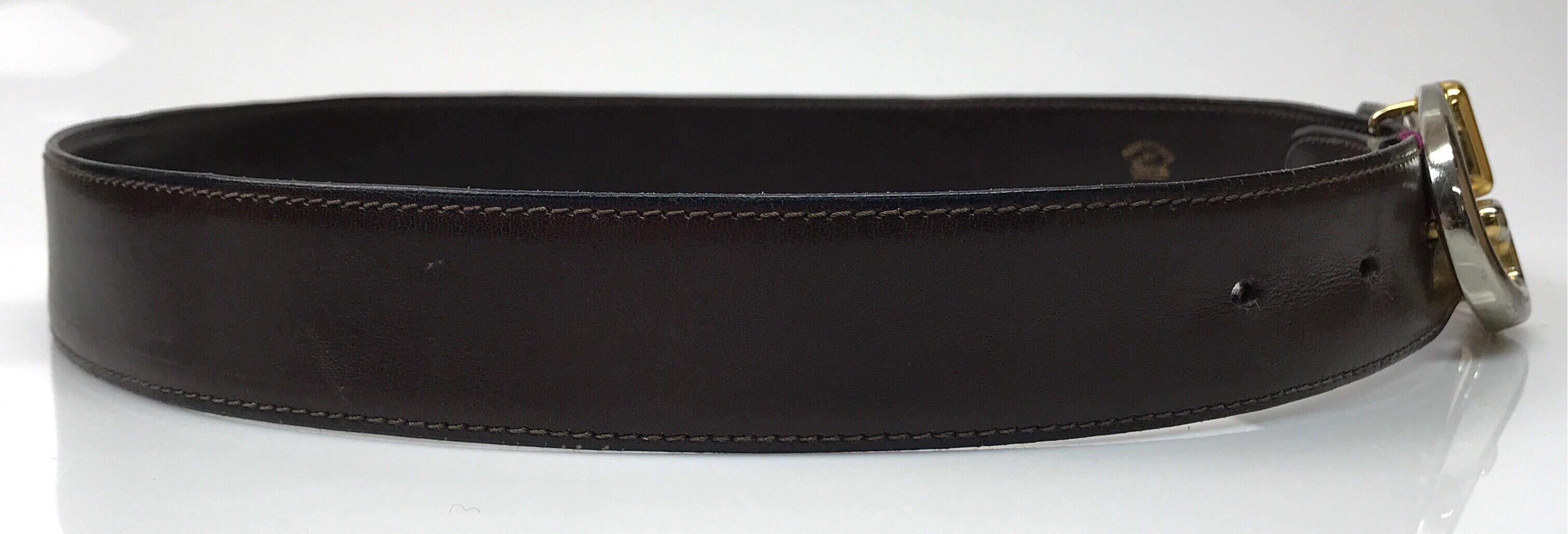 Gucci Brown Leather Belt w/ Silver/ Gold Buckle- 75/30. This amazing Gucci belt is in good condition. The buckle holes show sign of use and there are small scratches in the leather. The belt is made of brown soft leather on the inside and outside.