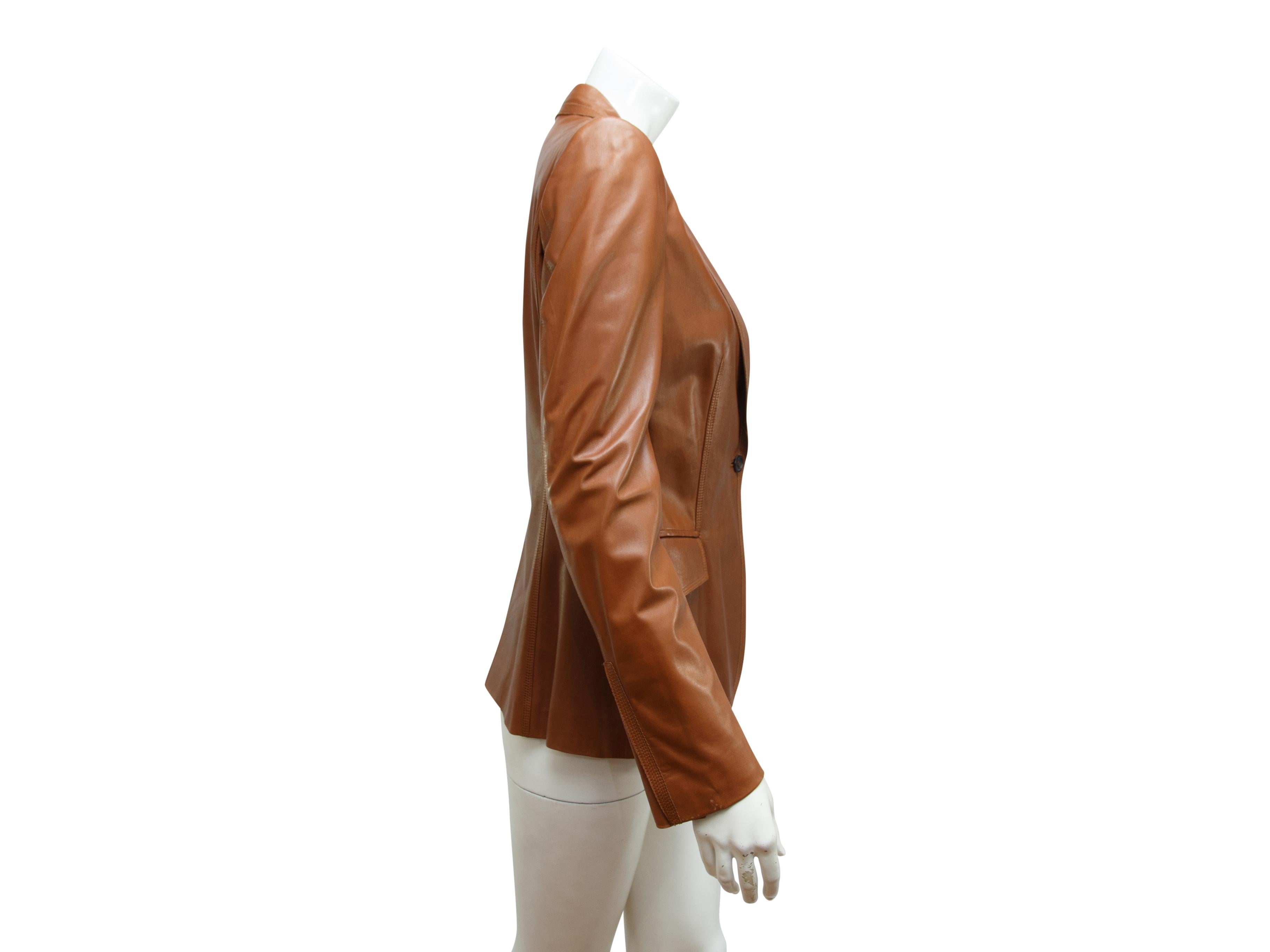 Product details:  Brown leather blazer by Gucci.  Peak lapel.  Long sleeves.  Single-button closure.  Besom chest pocket.  Waist flap pockets.  Back center hem vent.  Label size IT 42.  30