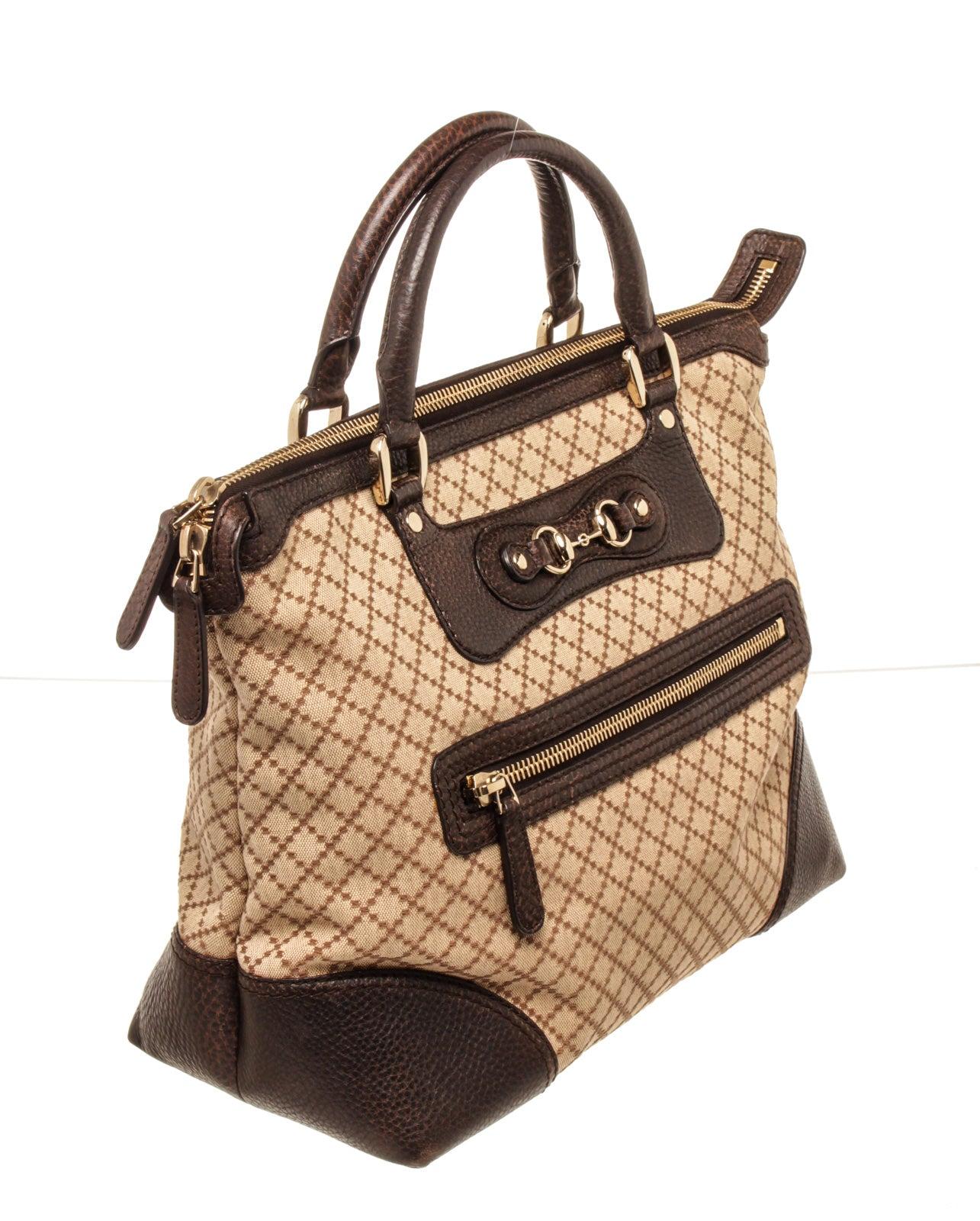 Gucci Brown Leather Catherine Tote Bag. Features green and red canvas top handles with dark brown leather grips and top zipper trim. This zipper opens to a brown fabric interior with one zipper pocket and one slip pocket,
44875MSC