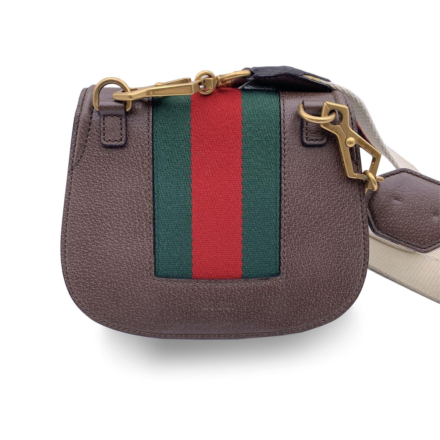 Beautiful GUCCI 'Totem' small shoulder bag in brown leather. Flap closure with beautiful crystal encrusted heart on the front Green/red/green striped detailing. Beige lining. 1 side open pocket inside. Removable shoulder strap. 'GUCCI - made in