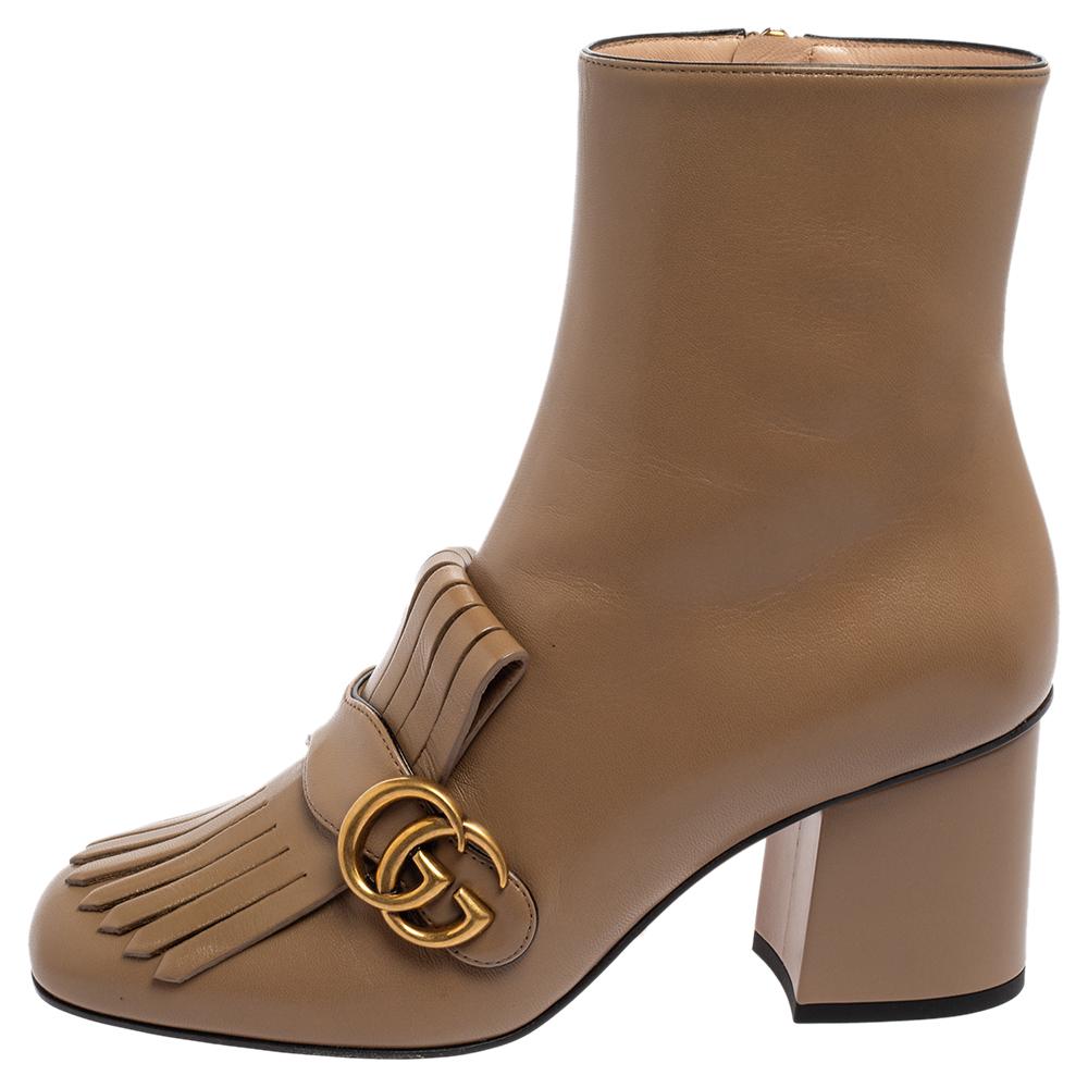 If you are a style enthusiast, then these Gucci ankle boots are a perfect fit for you. Their leather exterior is adorned with folded fringes, a gold-tone GG motif, and square toes. The side zipper closure and block heels give the pair a functional