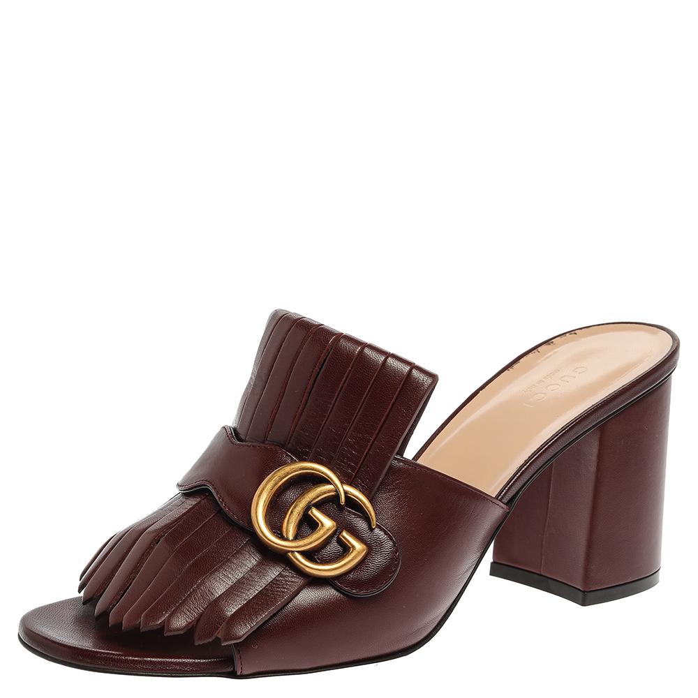 Absolutely on-trend and easy to flaunt, this pair of mules by Gucci is a true stunner. The brown mules have been crafted from leather and styled with folded fringes and the brand's signature GG on the uppers. Open toes and a set of block heels