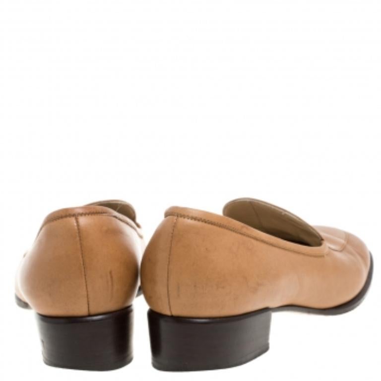 A pair of loafer pumps to reflect your classic taste in fashion is this one from Gucci. They are crafted from brown leather and designed to envelop your feet with comfort. The shoes feature gold-tone logo accents on the uppers and a set of short