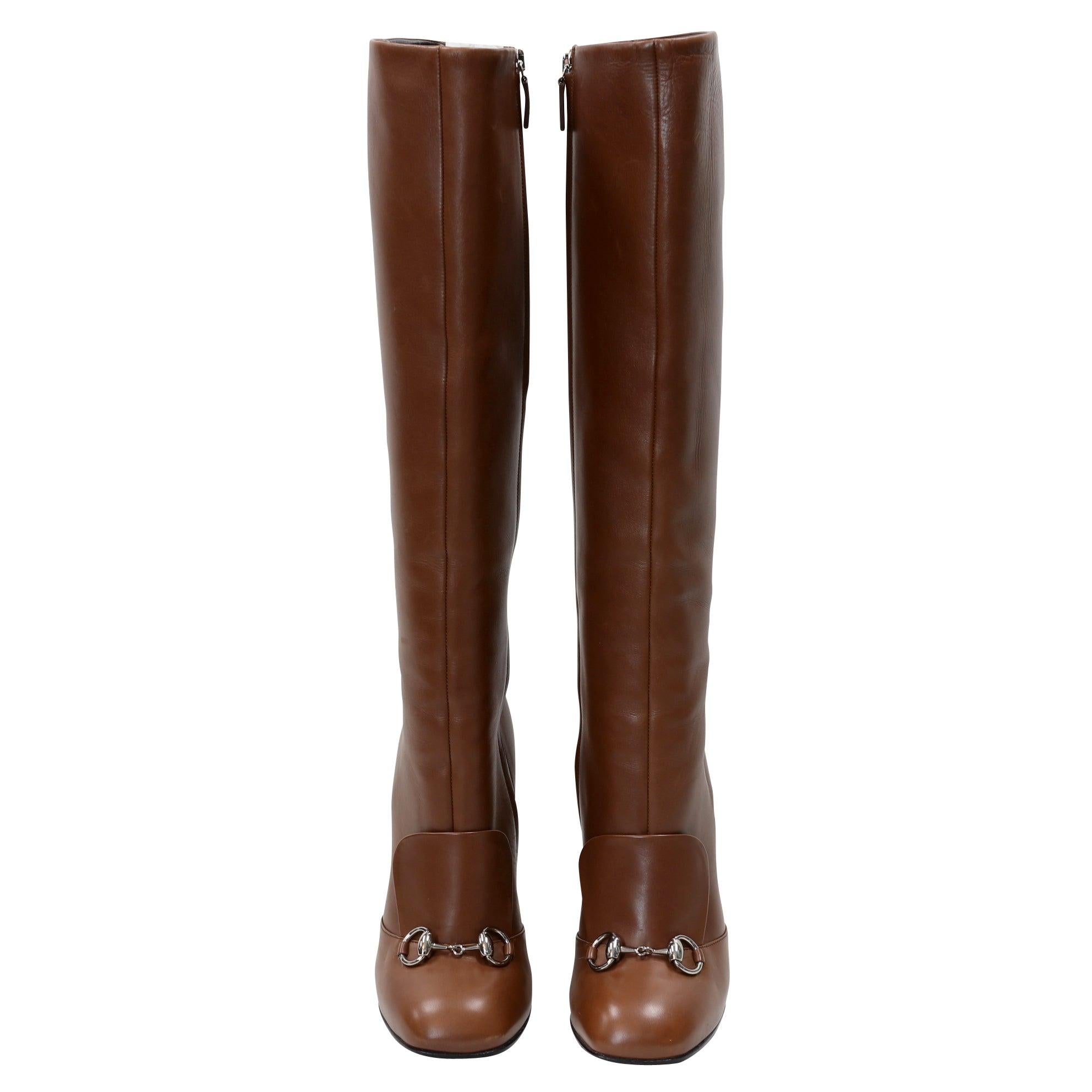 These Gucci boots have a vintage-inspired look. Made from honey brown smooth leather, these boots feature a silver tone horsebit at the vamp with a modern flap detail and a block heel. Leather lined uppers make for a comfortable fit. These boots are
