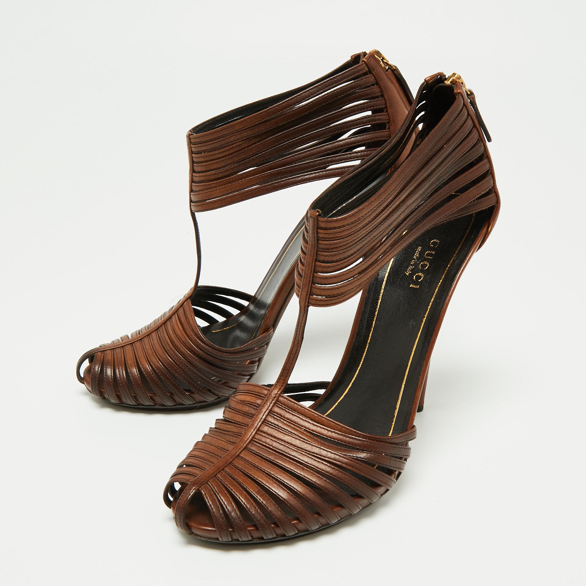 These sandals from Gucci are absolutely breathtaking! They are crafted from brown leather in a strappy layout with round toes and zippers on the counters. Balanced on 12.5 cm heels, this lovely pair will have everyone in admiration.

