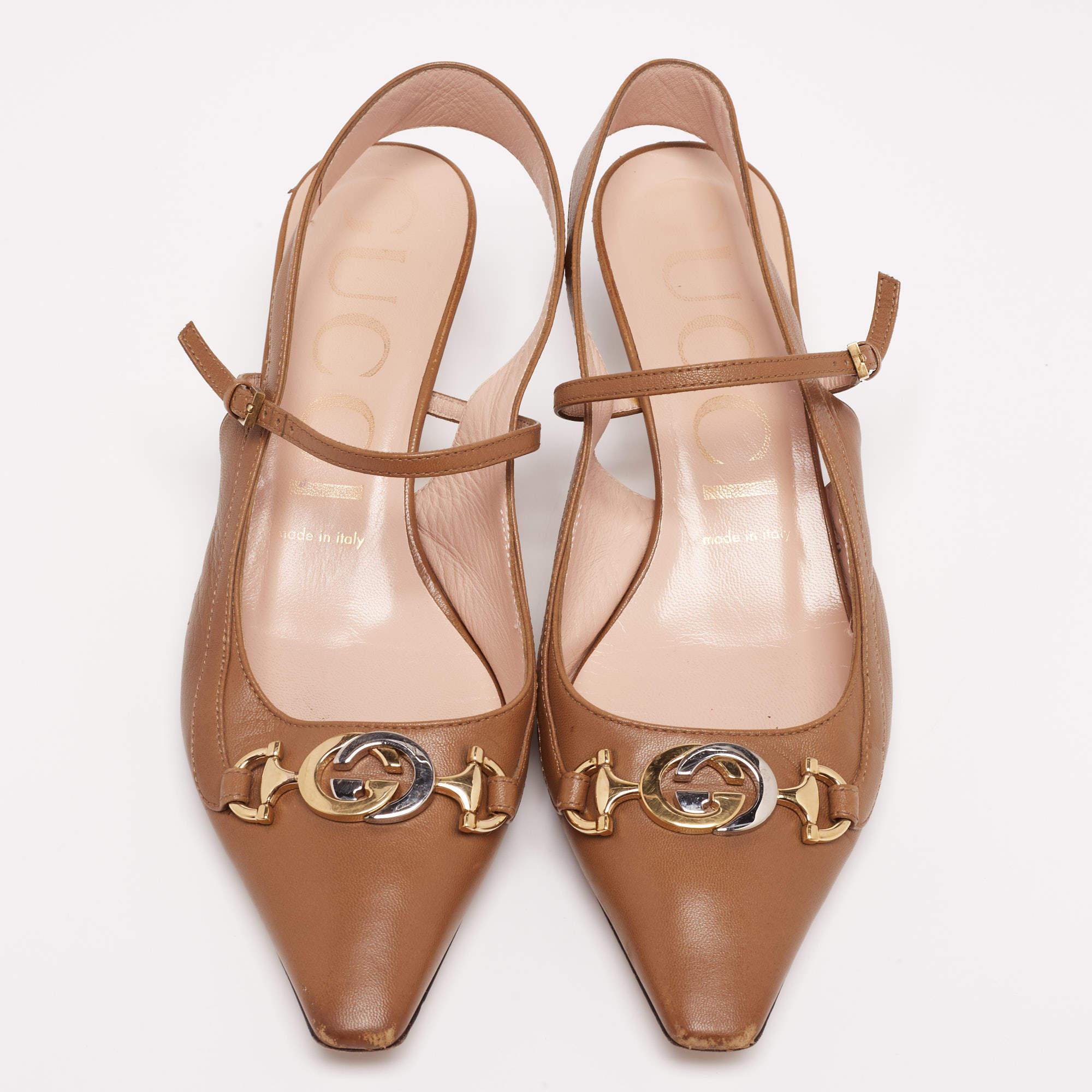 Gucci's Zumi sandal is a signature design with a distinct interlocking G Horsebit symbol on the uppers. The name is inspired by Zumi Rosow, who is an actress and musician. This brown pair arrives in leather and is raised on 5cm heels. It is finished