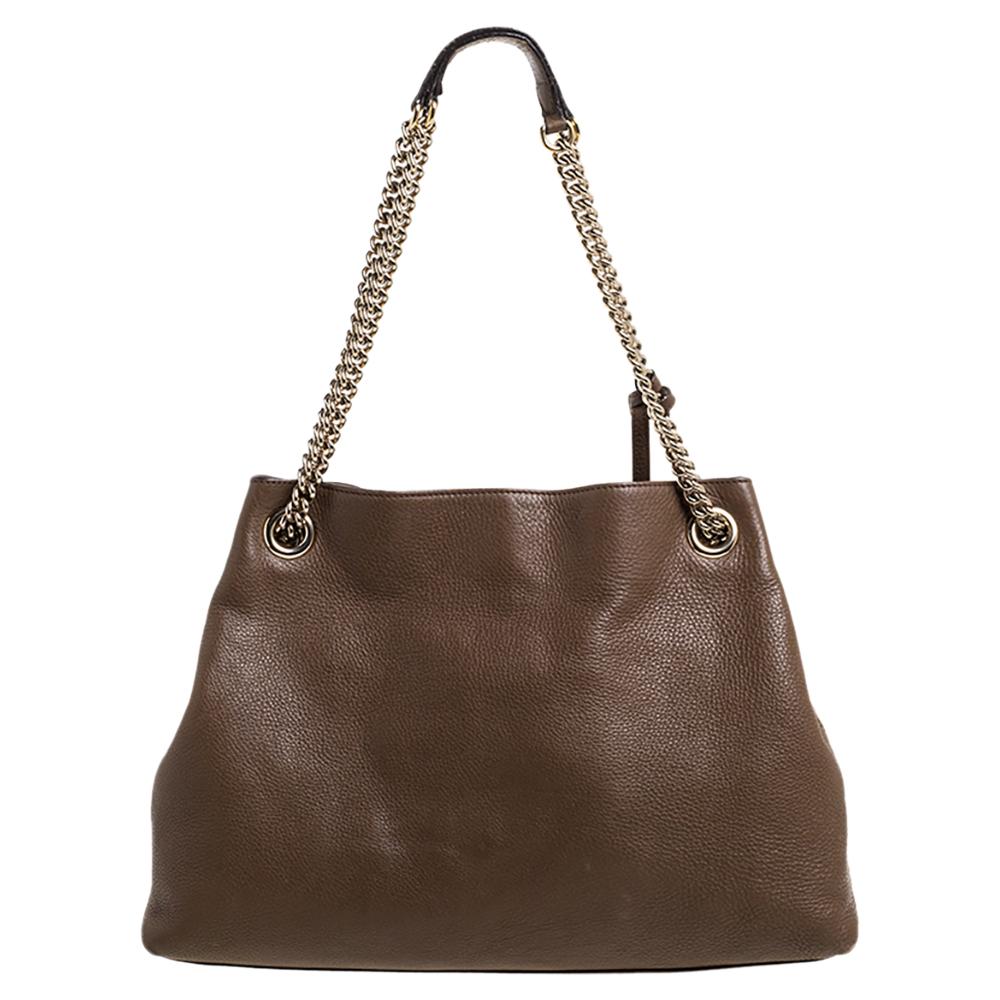 The Soho tote has captured the hearts of women around the globe! This bag is constructed from brown leather and designed with the signature GG logo on the front. It comes endowed with a spacious canvas interior for your essentials, two chain handles