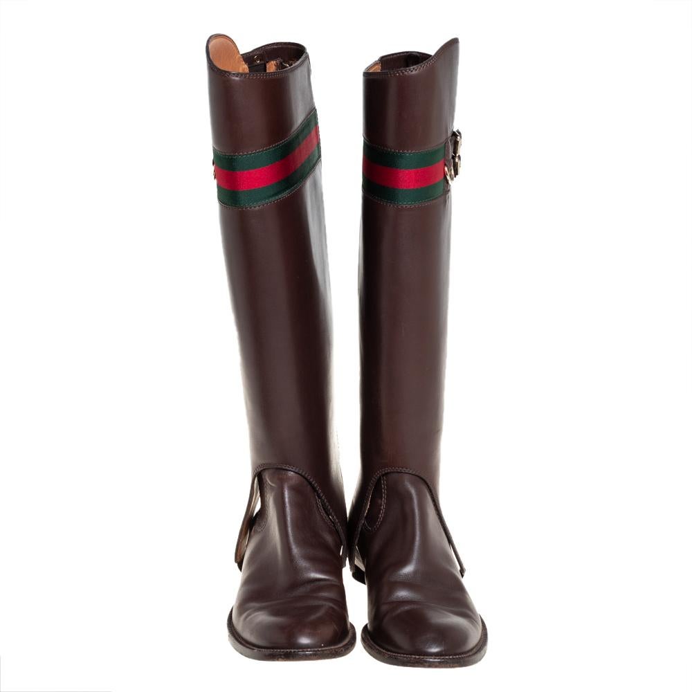 What's not to love about boots made of quality leather! Take a look at this lovely pair of Gucci boots that speak style with its silhouette and simple design. They've been crafted from leather and designed as round toes with web and buckle details