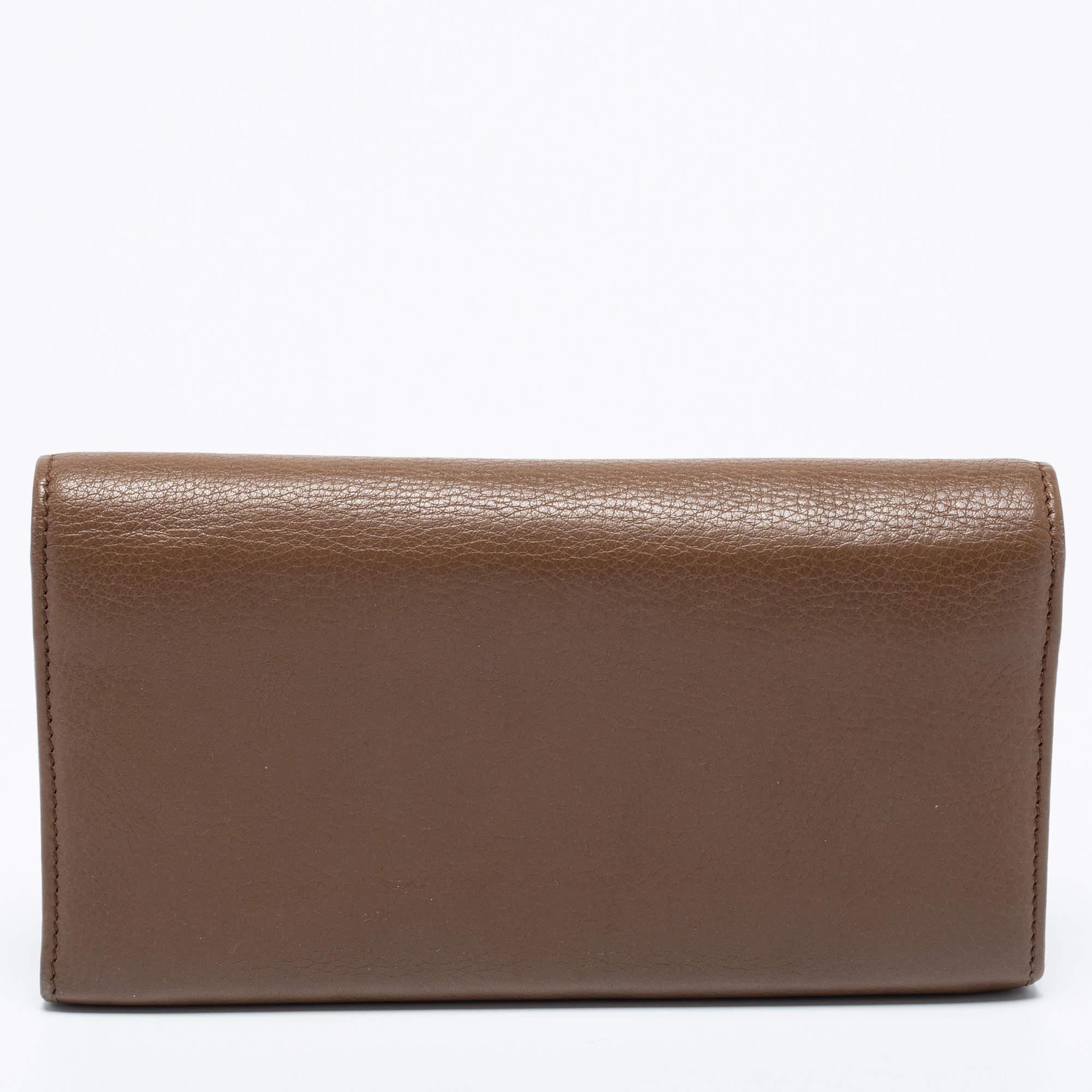 Made of brown leather, this Soho continental wallet from Gucci is a classy choice. It has a zip pocket and multiple card slots. The wallet is complete with the GG logo on the front.

