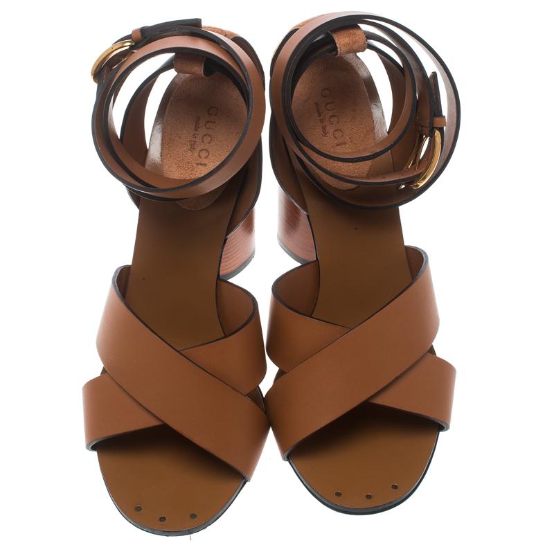Mesmerizing sandals are a closet essential and there's no reason why yours must be left behind. No better start than with these ones from Gucci! Carrying leather cross straps and ankle wraps, these brown sandals come beautifully balanced on 11.5 cm