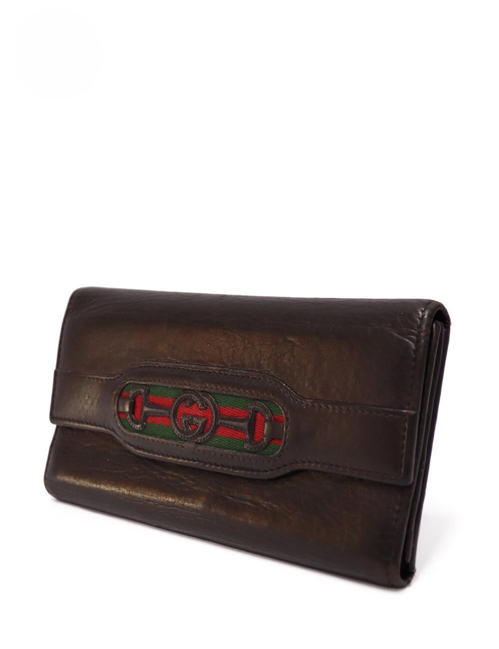 Gucci Brown Leather Striped Logo Wallet , features twelve card pockets, three slip, and one photo pocket.

Material: Leather
Height: 10cm
Width: 19cm
Depth: 2cm
Overall condition: Good
Interior condition: Signs of use
External condition: Leather