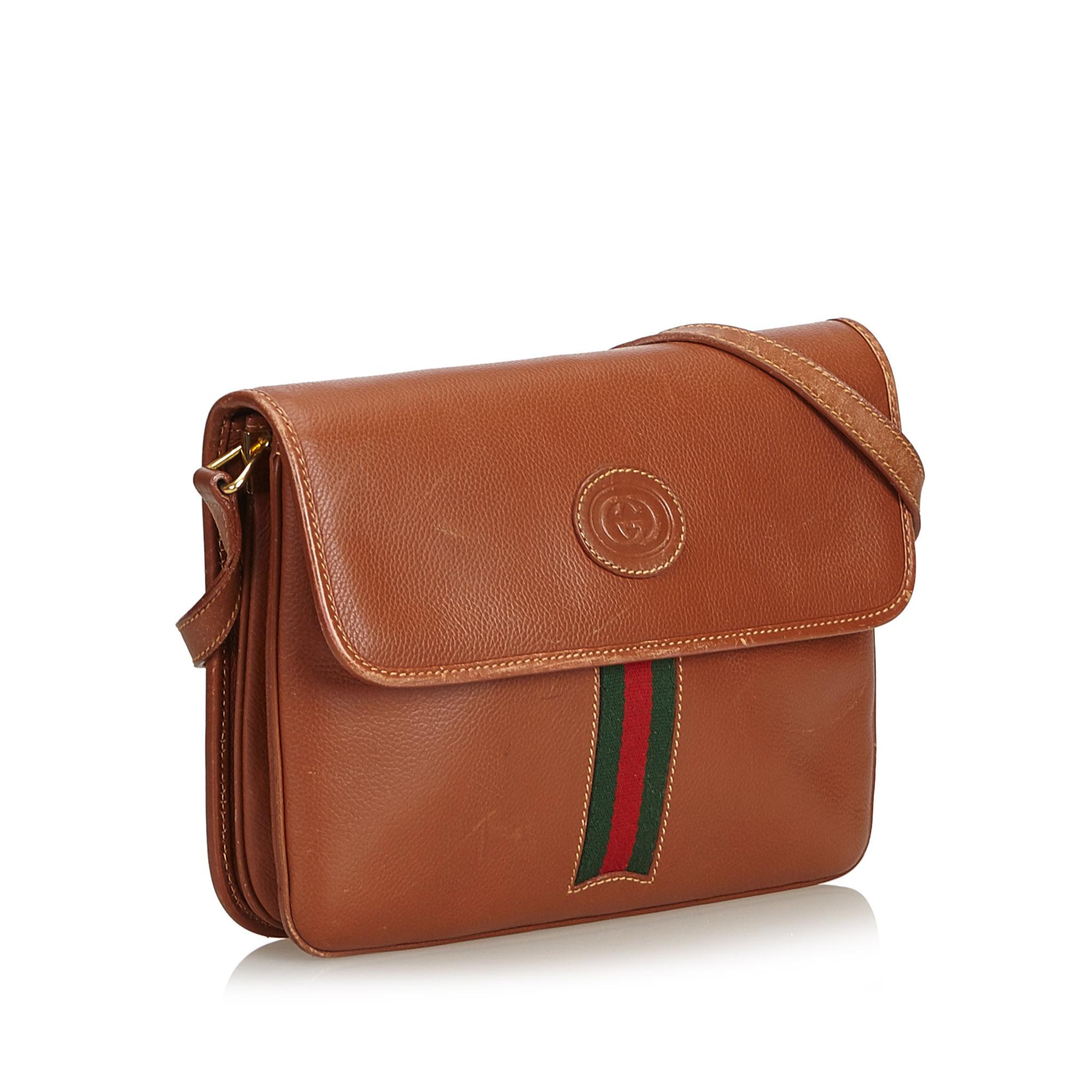 This crossbody bag features a leather body, flat leather crossbody strap, flap with magnetic closure, three interior compartments, and an interior zip pocket. It carries as B condition rating.

Inclusions: 
This item does not come with