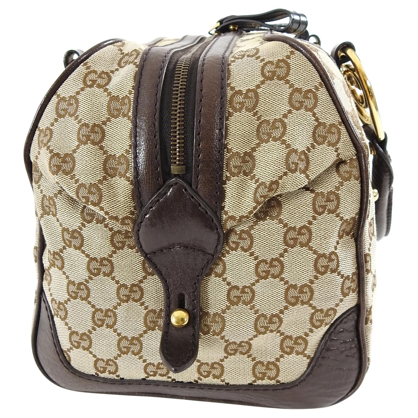 Gucci Brown Monogram Canvas Boston Doctor Bag with Logo.  Brown monogram canvas body with dark brown and black leather trim.  Brass GG logo details and studs, double rolled leather handles, pleated centre bottom.  Excellent pre-owned condition with