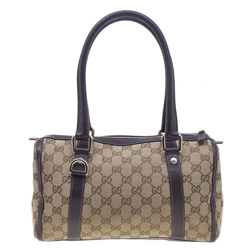 This classic monogram Small Joy Boston by Gucci is accustomed to keep all your necessary belongings safe and intact. It's crafted from Gucci’s iconic GG monogram canvas. It features a top zip closure, brown leather trim outline on the corners and