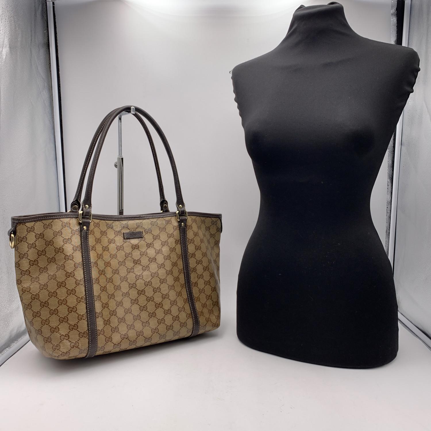 Gucci tote crafted in brown monogram Crystal canvas with brown genuine leather trim and handles. Light gold hardware. Magnetic button closure on top. Inside,brown fabric lining with 1 side open pocket. 'GUCCI - made in italy' tag inside (with serial