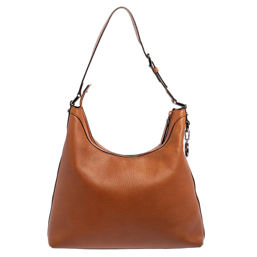 Here’s a chic handbag for those passionate bag collectors. Crafted from brown pebbled leather, it is accented with gunmetal-tone hardware and a GG charm. The bag features a flat leather handle. The top zip closure opens into a fabric-lined interior.