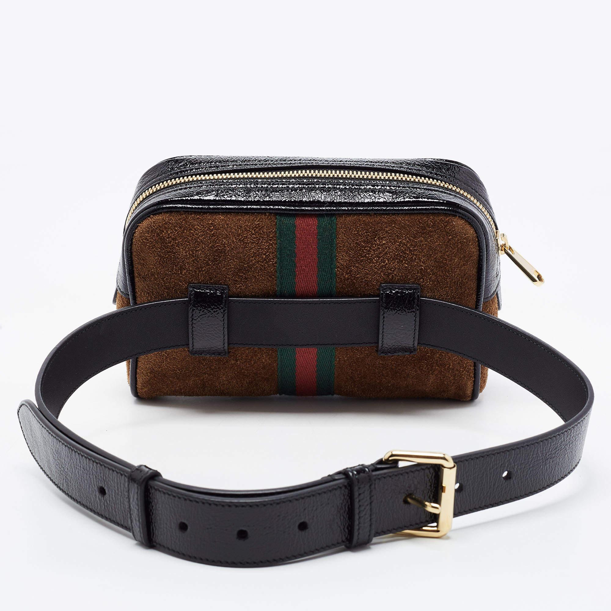 Add class to your look by accessorizing with this Gucci belt bag. Designed expertly, this creation features a suede body enhanced with patent leather trims. The bag flaunts signature GG on the front, along with the Web detailing. It is complete with