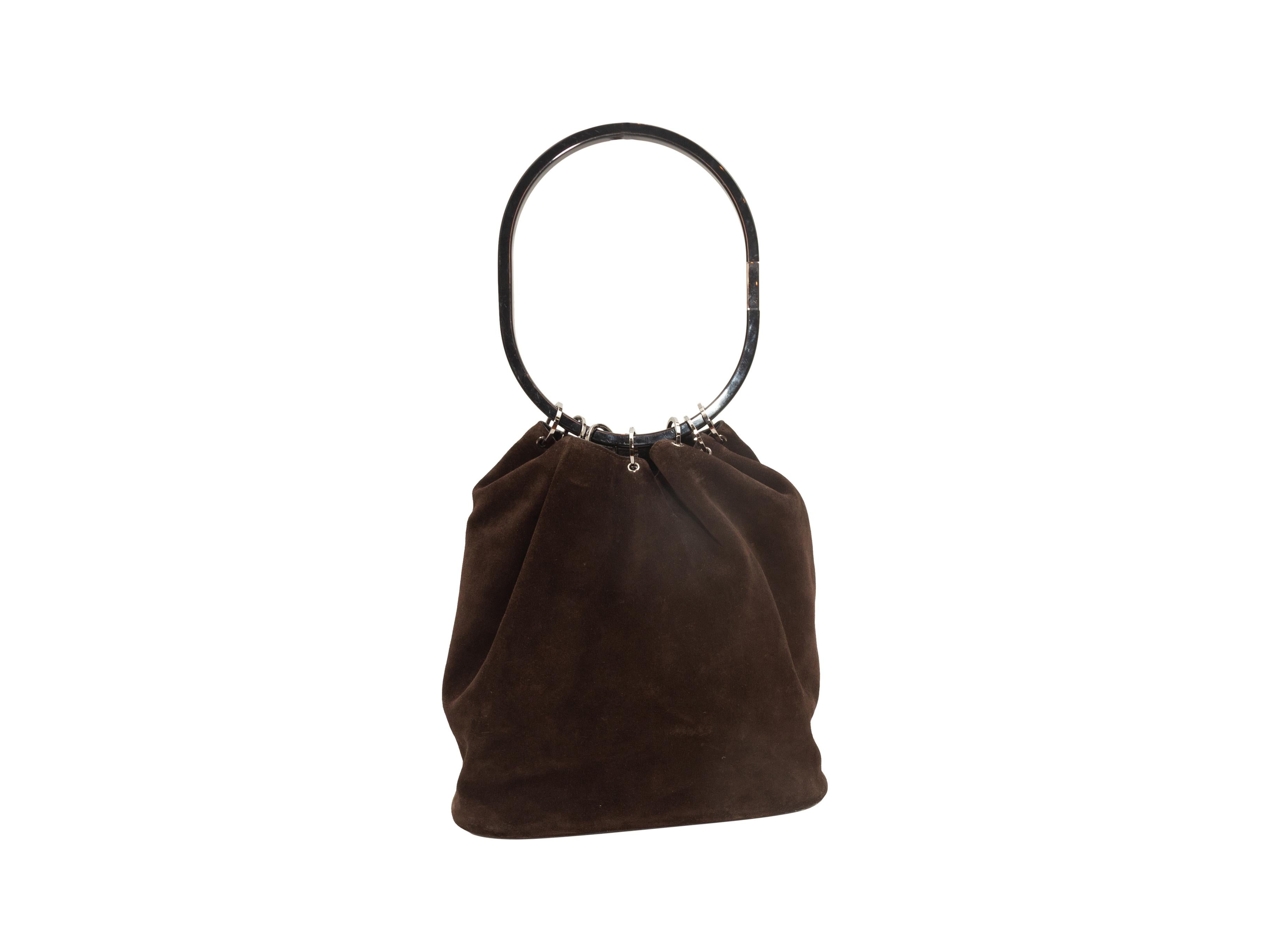 Product details: Vintage brown suede bucket bag by Gucci. Silver-tone hardware. Single hoop handle. 11