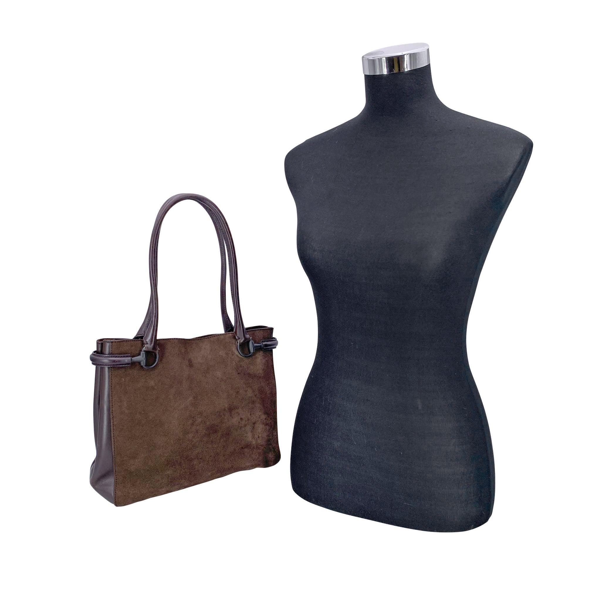 Rich in texture and unmistakably iconic, this beautiful Gucci tote bag is crafted from supple brown suede with smooth leather accents, blending classic materials in a warm, earthy palette. The silhouette is elevated by double rolled shoulder straps