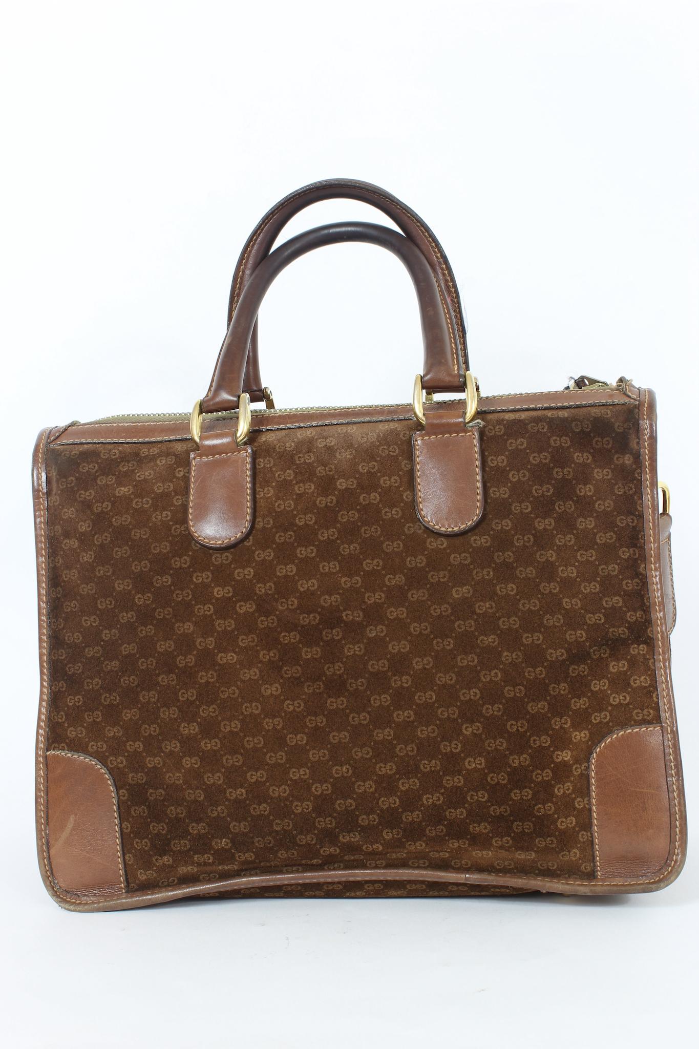Gucci vintage 70s handbag. Brown trunk bag, in suede, monogram print, leather finishes and golden metal details. Rounded leather handles, beige suede interior with pocket. Made in italy.

Cod: 14 02 1885

Height: 25cm
Width: 32cm
Depth: