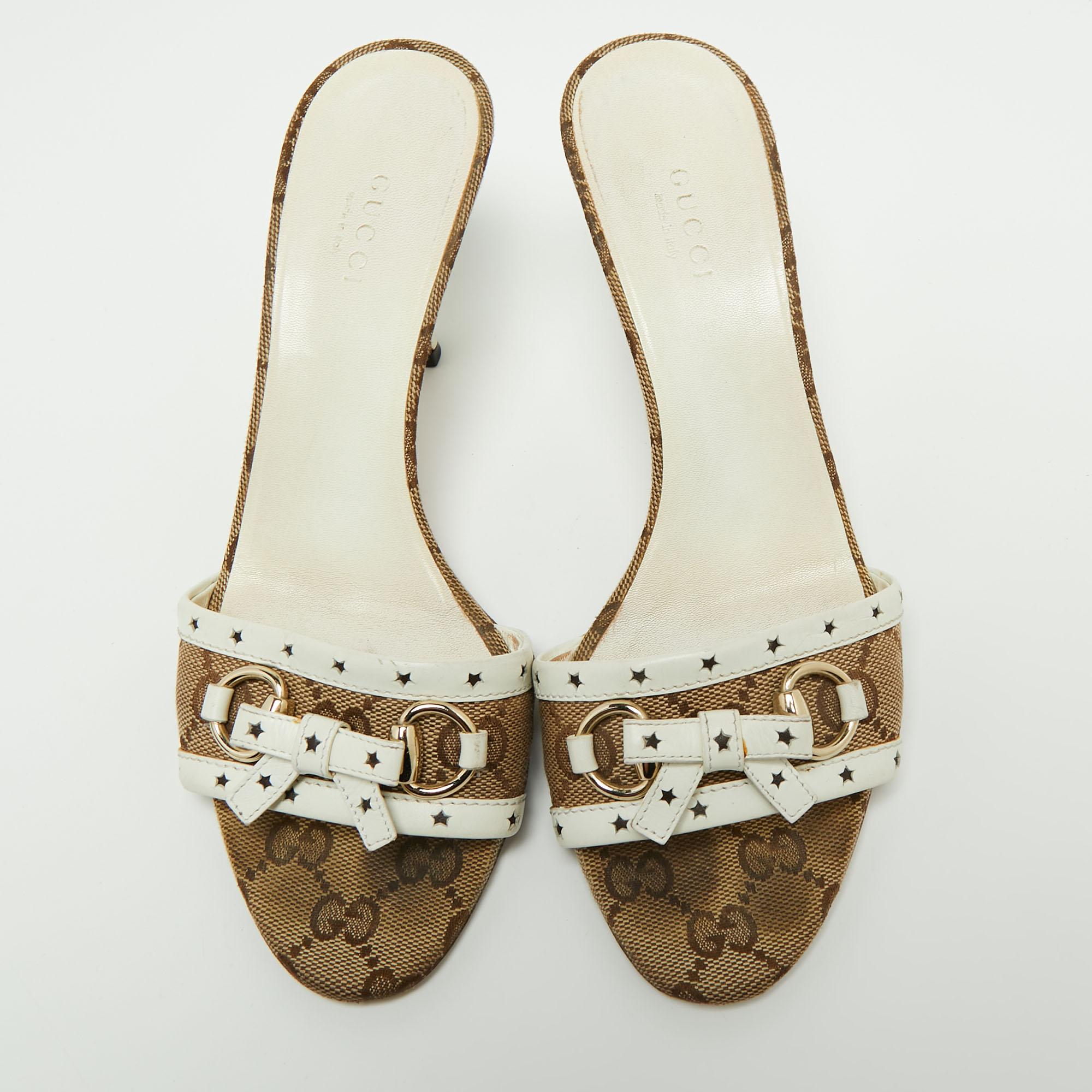 Be it casual or formal outings, these slide sandals from Gucci will add the right amount of elegance and poise to your ensemble. They are crafted from brown-white GG canvas and leather, with a gold-toned bow and logo motif placed on the upper. Their