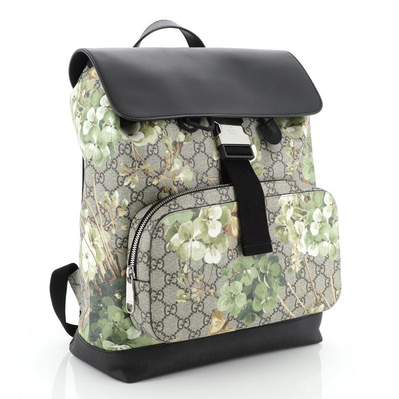 This Gucci Buckle Backpack Blooms Print GG Coated Canvas and Leather Medium, crafted from GG supreme coated canvas with green blooms print, features adjustable padded nylon shoulder straps, top handle, front flap with metal buckle closure, exterior