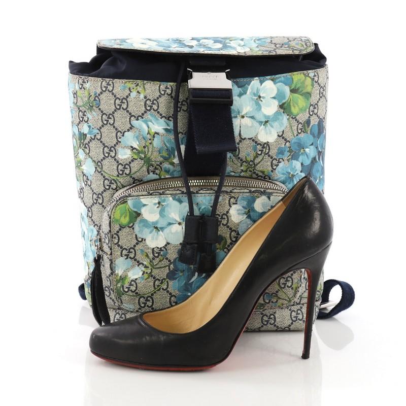 This Gucci Buckle Backpack Blooms Print GG Coated Canvas Small, crafted from blue blooms print GG coated canvas, features adjustable padded nylon shoulder straps, exterior front zip pocket, and silver-tone hardware. Its buckle and cinch closure