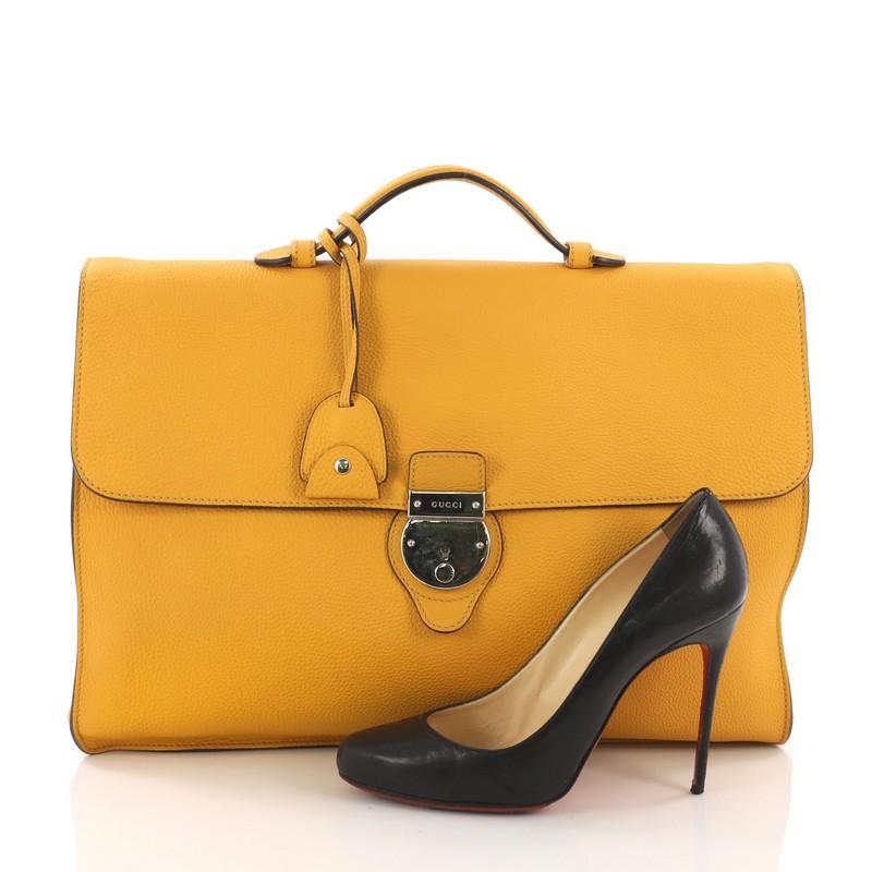 This Gucci Buckle Flap Briefcase Leather Large, crafted in yellow leather, features single top leather handle, frontal flap, and silver-tone hardware. Its push-clasp closure opens to a yellow suede interior with slip pocket. **Note: Shoe