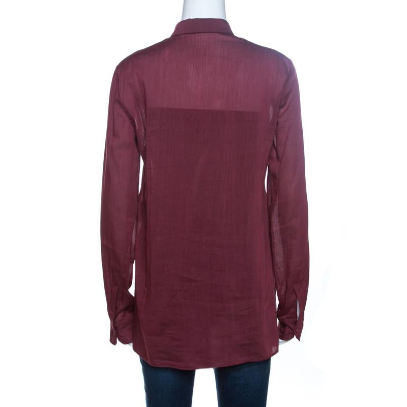 This lovely top comes from the house of Gucci is stylish and sophisticated. Crafted from 100% cotton, it comes in a lovely shade of burgundy. It is styled with long cuffed sleeves, lace trims, button closure, simple collar and a good fit. It is