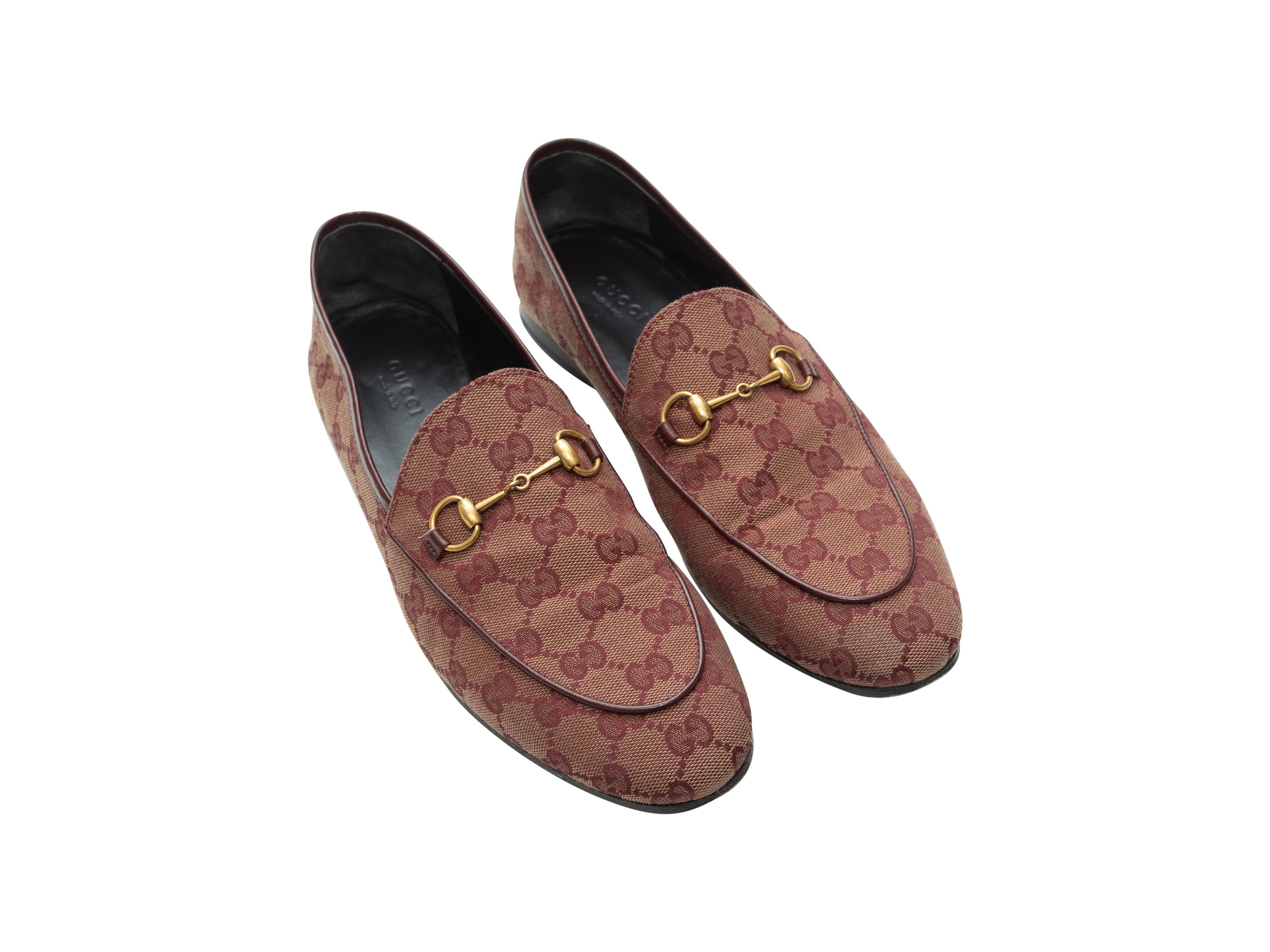 Product details: Burgundy GG canvas round-toe loafers by Gucci. Slip-on style. Tonal leather trim throughout. Gold-tone horsebit accents at tops. Designer size 40.5. 0.5
