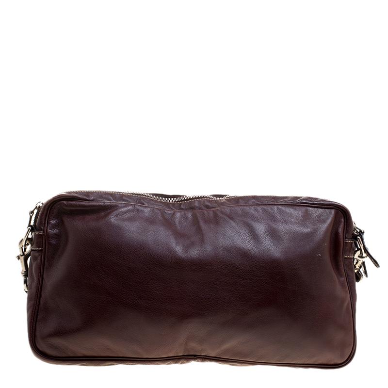 Waist bags are back on trend and we are not disappointed! This one from Gucci is a fine choice for you to join the trend. Made from leather, the burgundy bag comes with a shoulder strap, multiple nylon compartments, and gold-tone