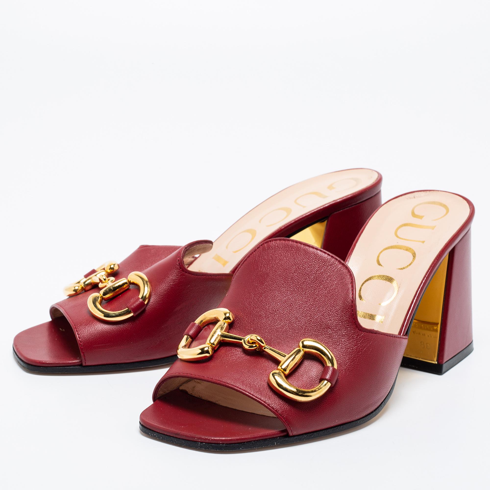 Open square-toed shoes are having a fashion moment right now! These Gucci sandals are made using glossy leather in a burgundy shade with the iconic Horsebit on the uppers for a signature touch. Chunky block heels will not only add an edge but oodles
