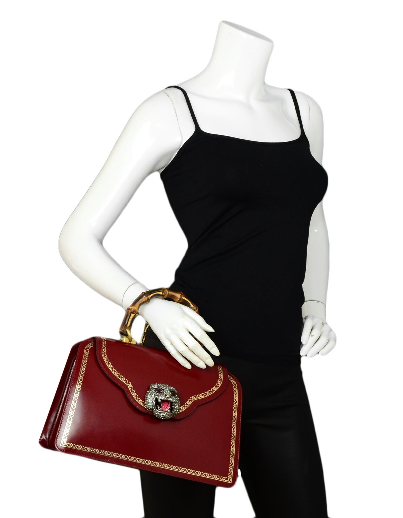 Gucci Burgundy Leather Medium Thiara Top Handle Bag rt $4,900

Made In: Italy
Color: Burgundy
Hardware: Goldtone hardware
Materials: Burgundy, bamboo handle
Lining: Floral satin lining
Closure/Opening: Top flap with embellished push flap 
Exterior