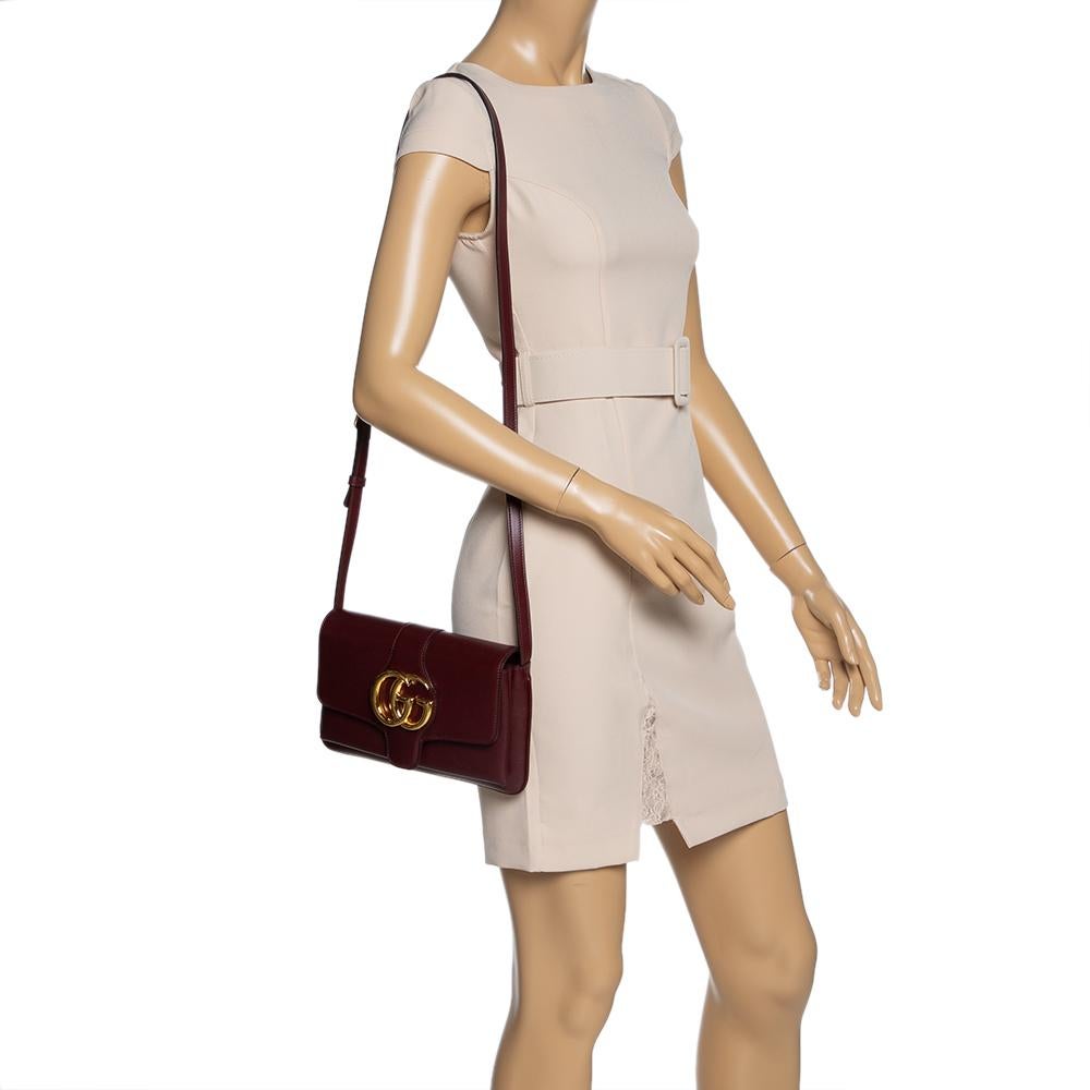 Gucci's Arli bag is a fashionmonger's favourite choice. Crafted from burgundy leather, the front is decorated with the iconic 'GG' hardware in gold-tone and the flap opens to a canvas-lined interior with two separate compartments and a zipped