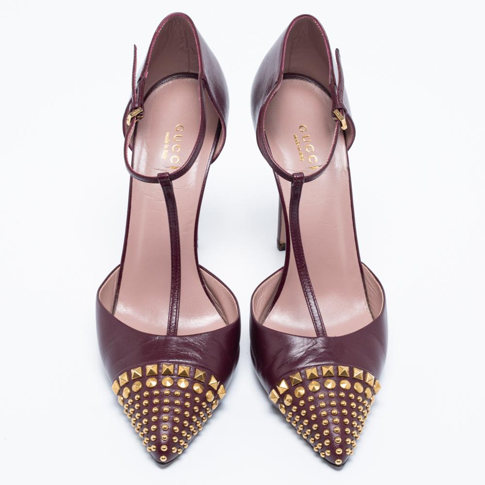 These pumps from the House of Gucci will certainly make you look classy and polished! They are created using burgundy leather, wth studded embellishments on the toes. They showcase gold-tone hardware, a T-strap, and slim heels. Look gorgeous as you