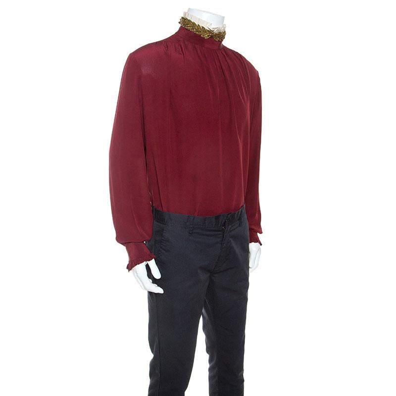 This shirt is from Gucci's menswear collection and it is exuding style in every detail. Tailored beautifully using silk, the burgundy shirt features button closure at the back, ruffle trims on the long sleeves and a gorgeous collar featuring leaf