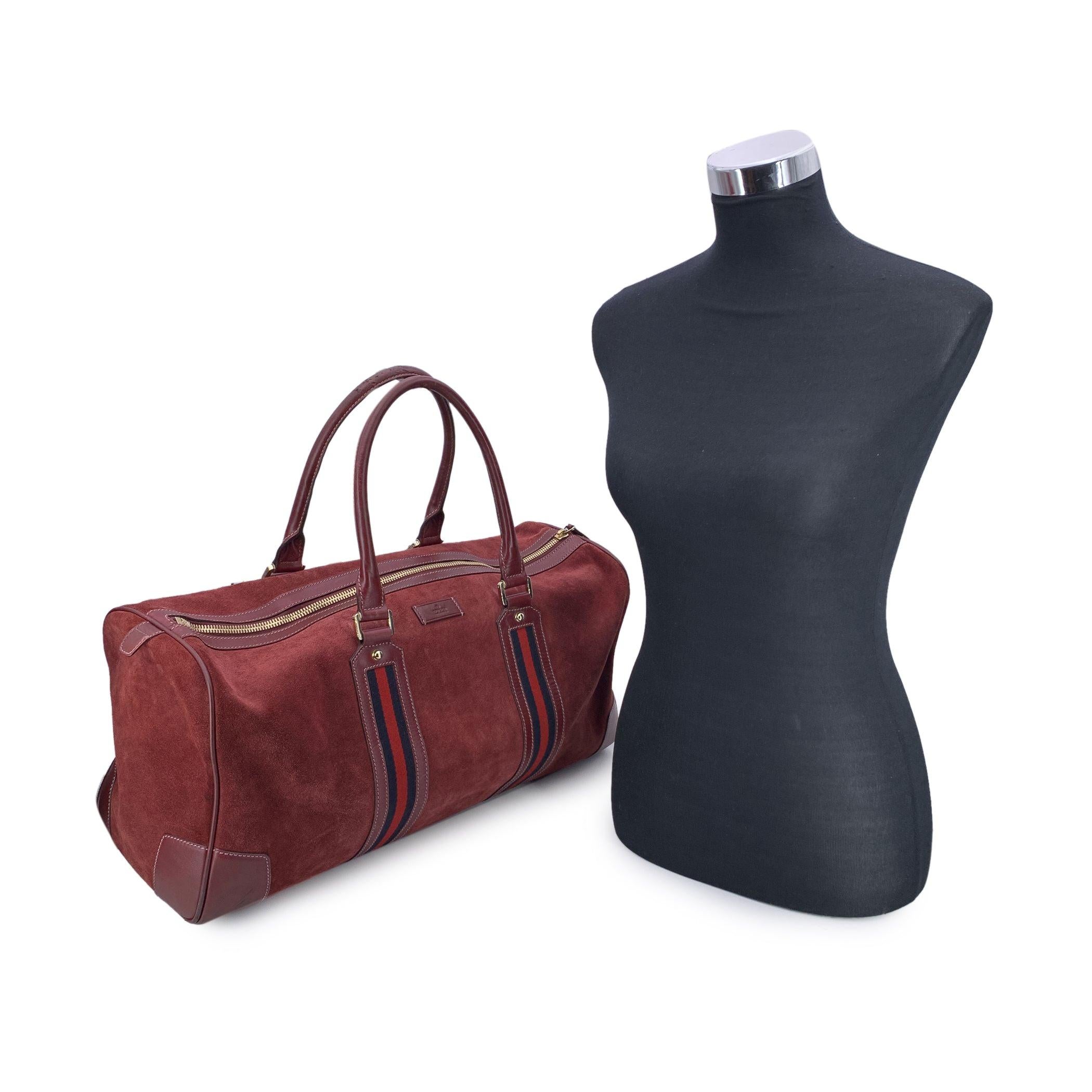 Step into the world of timeless luxury with this Vintage Gucci Duffle Bag, a quintessential piece for the discerning traveler. Crafted from burgundy suede and leather, it exudes the sophistication of classic Gucci design, complemented by luxurious